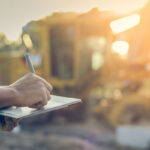 Photo of a construction worker using a tablet at a construction site