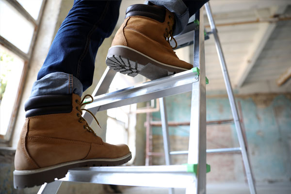 Photo of a worker climbing a ladder